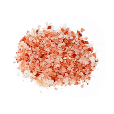 Close-up view of dark pink Himalayan rock salt granules in bulk, showcasing natural crystal texture and mineral-rich color on a white background.