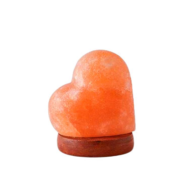 Heart shape rock salt lamp made from natural Himalayan crystal salt glowing with warm light for home décor, gifting, and wholesale supply